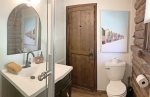 Main level bathroom has a new shower for 2023 and plenty of storage space